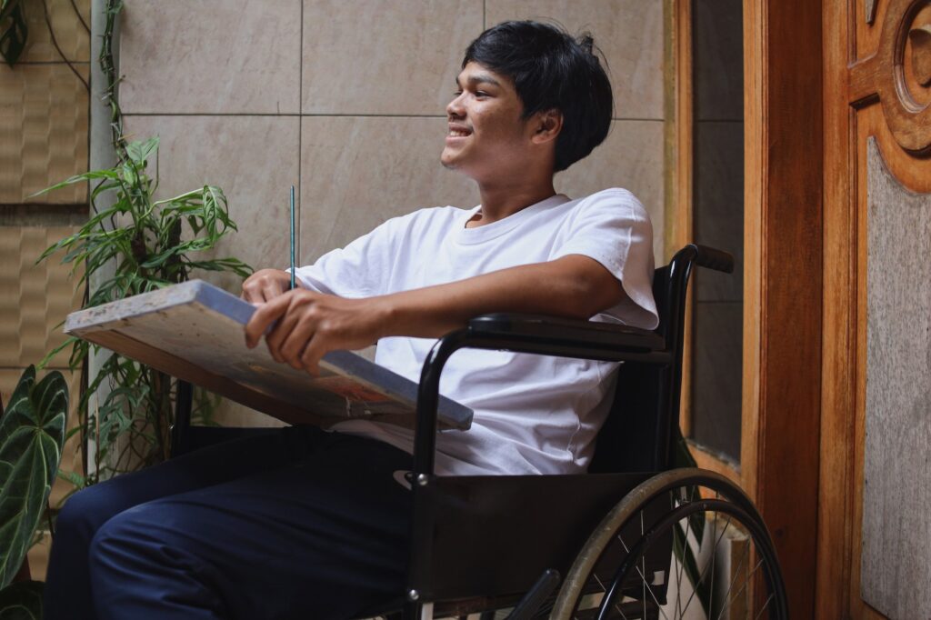 Disabled Asian man on wheelchair smiling